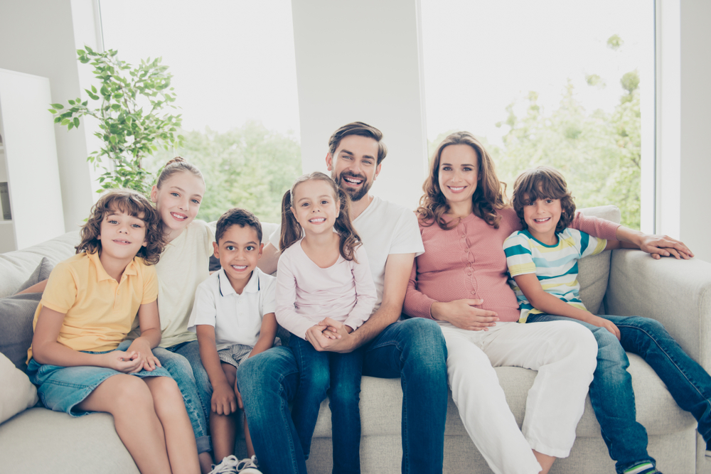 Featured Header image showing a blended family sitting on a couch.
